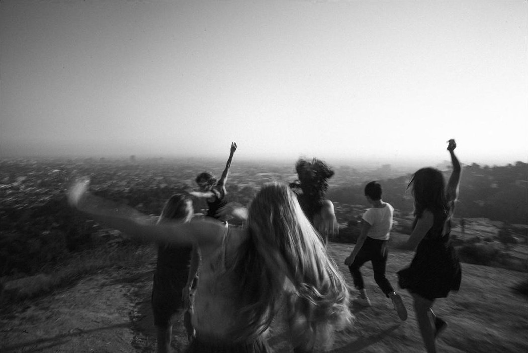 A group in motion on a hillside above Los Angeles